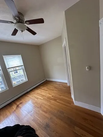 a view of an empty room and wooden floor