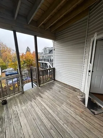 a view of a balcony with wooden floor