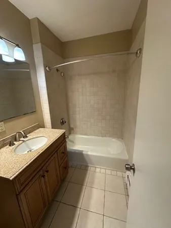a bathroom with a bathtub a sink and a mirror