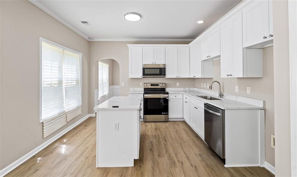 473 Greyhawk Way Fairburn, GA 30213 - Photo 7 of 34 a kitchen with granite countertop a stove top oven sink and cabinets