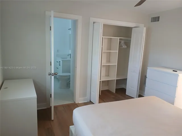 a bedroom with a bed and utility room