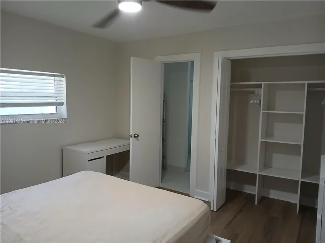 a bedroom with a bed and a closet