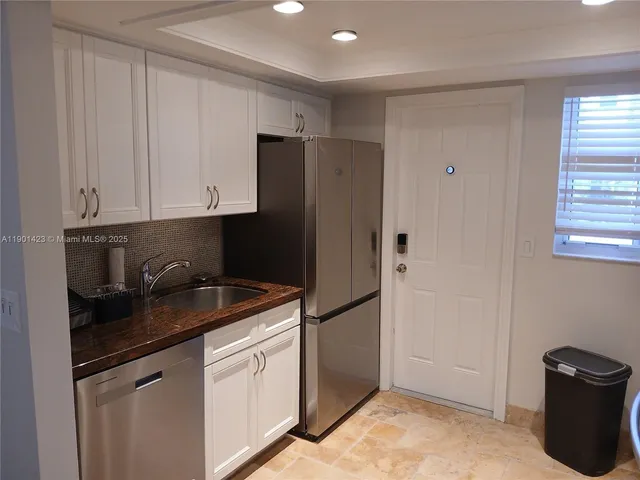 a kitchen with a refrigerator and a sink