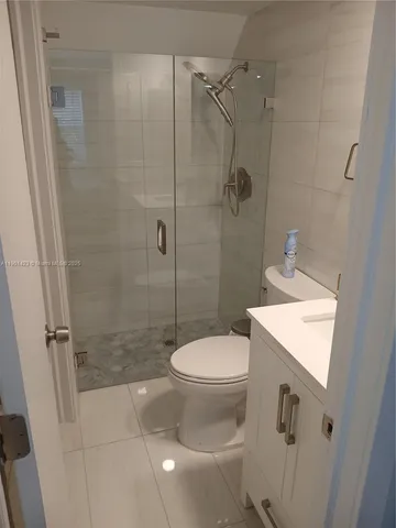 a bathroom with a shower a toilet and sink