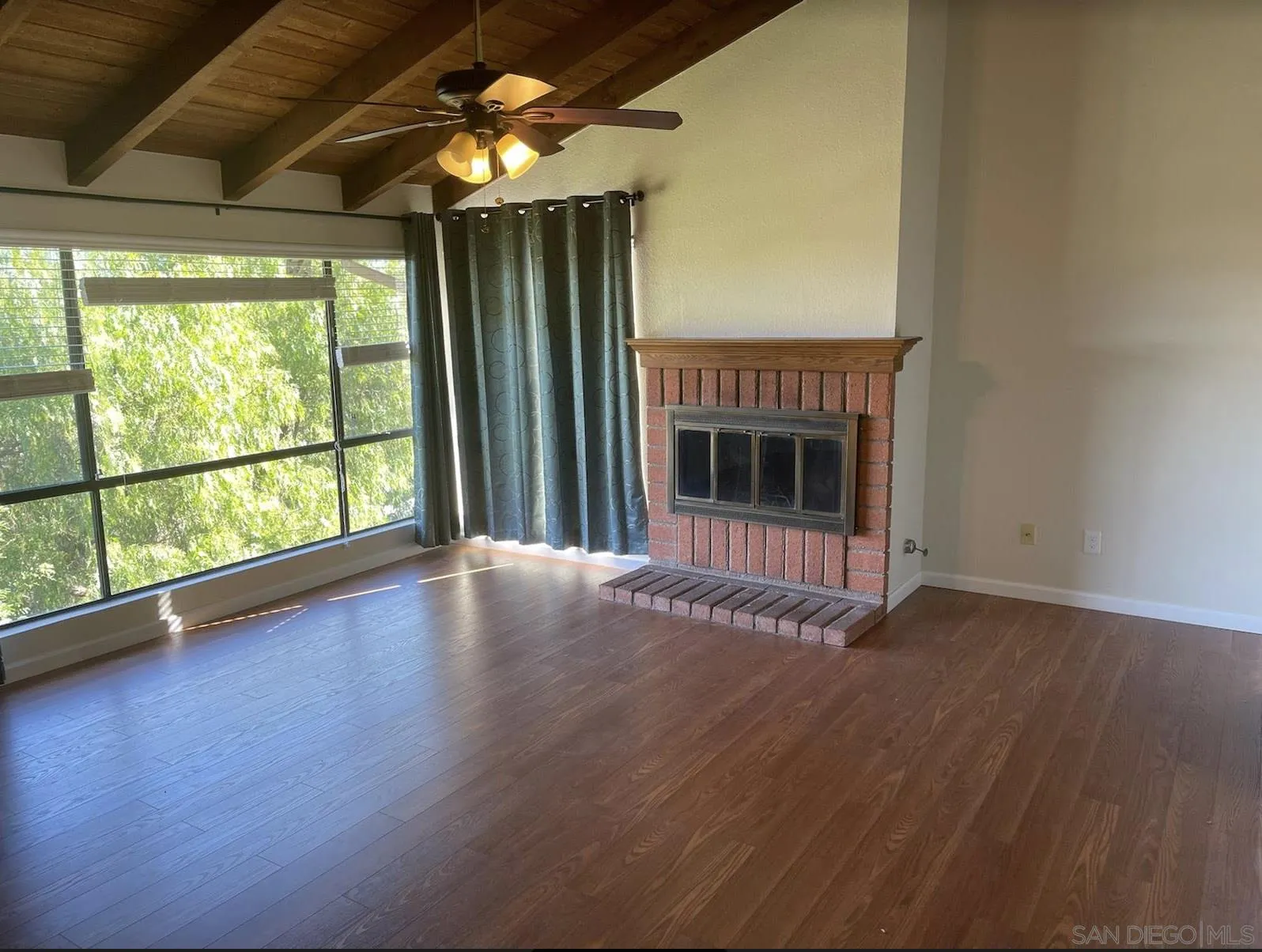 6555 Caminito Scioto La Jolla, CA 92037 - Photo 6 of 12 a view of empty room with wooden floor and fan