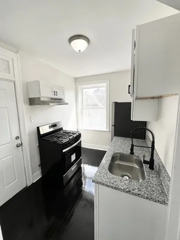 a kitchen that has a sink and a stove