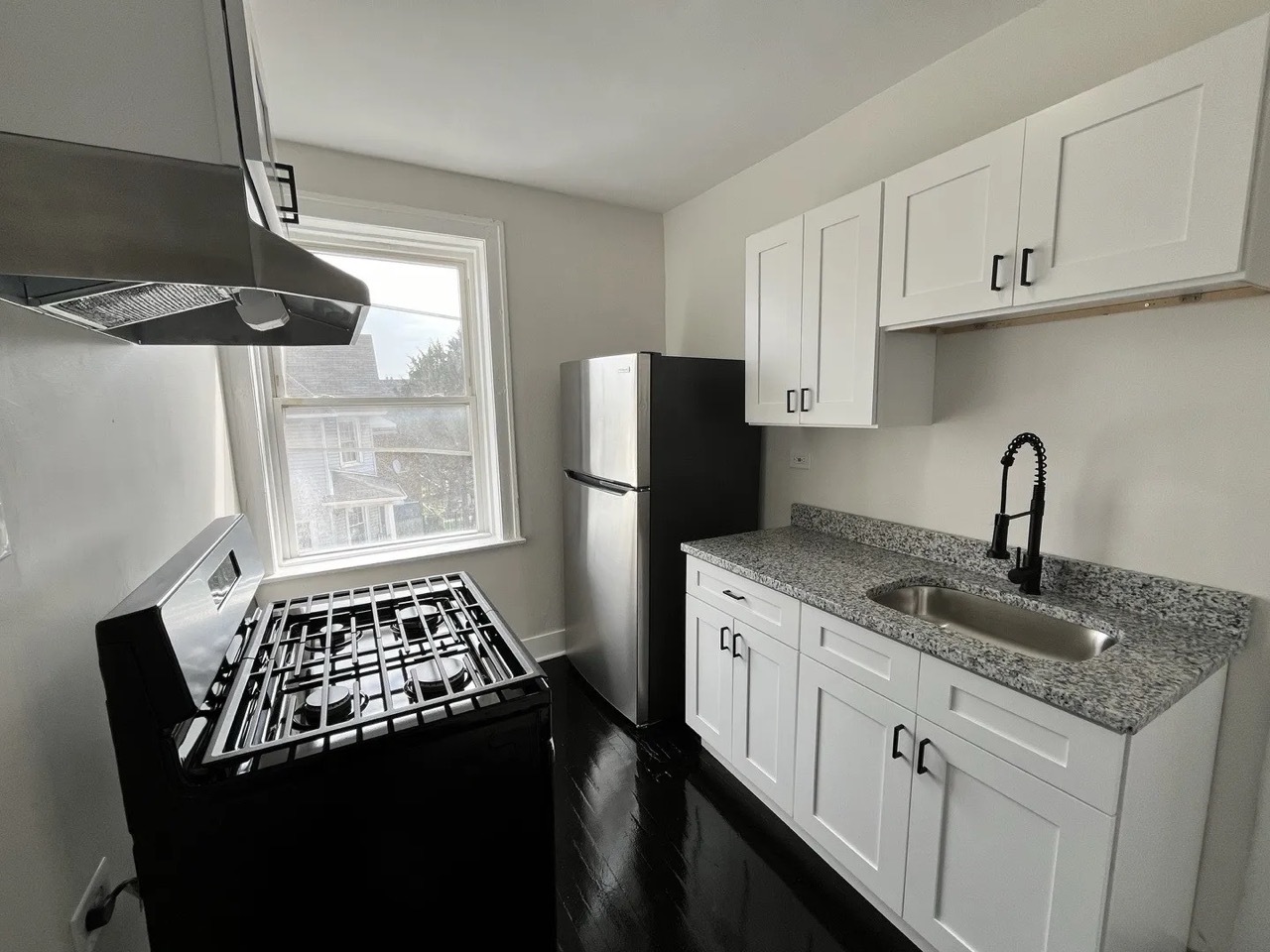4126 West 24th Place, Unit L3 Chicago, IL 60623 - Photo 8 of 11 a kitchen with stainless steel appliances granite countertop a sink stove and refrigerator