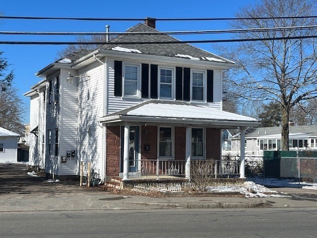 256 Broadway Taunton, MA 02780 - Photo 1 of 20 a front view of a house with large windows and a table