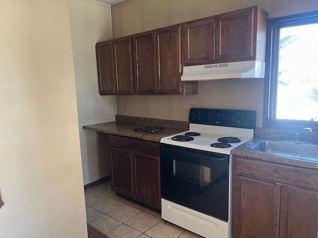 256 Broadway Taunton, MA 02780 - Photo 11 of 20 a kitchen with granite countertop a stove and a sink