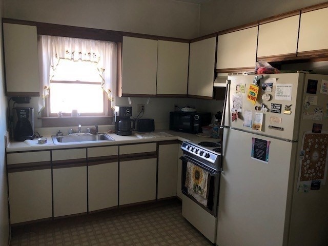 256 Broadway Taunton, MA 02780 - Photo 13 of 20 a kitchen with stainless steel appliances granite countertop a refrigerator a sink and a stove