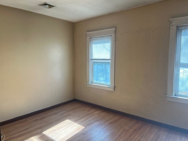 256 Broadway Taunton, MA 02780 - Photo 7 of 20 an empty room with wooden floor and windows