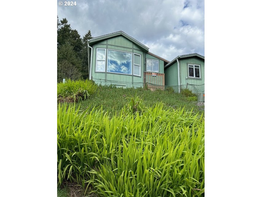 15061 Highway 101, Unit 4 Brookings, OR 97415 - Photo 1 of 12 a view of a garden with plants