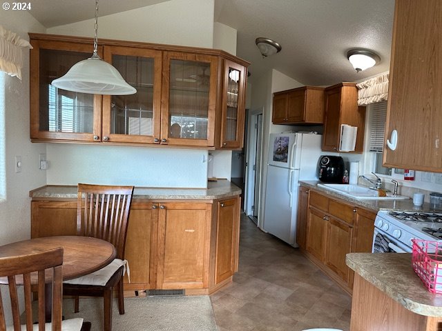 15061 Highway 101, Unit 4 Brookings, OR 97415 - Photo 2 of 12 a kitchen with stainless steel appliances granite countertop a stove a sink and a refrigerator
