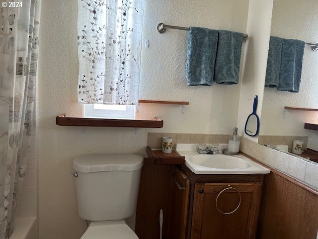 15061 Highway 101, Unit 4 Brookings, OR 97415 - Photo 5 of 12 a bathroom with a sink and a toilet