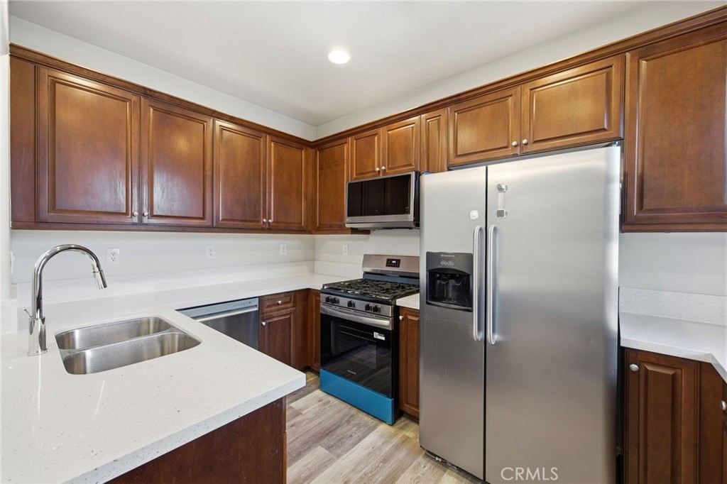 3603 Jetty Carlsbad, CA 92010 - Photo 11 of 43 a kitchen with a refrigerator sink and cabinets