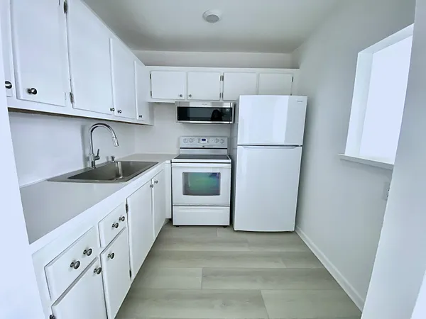 a white refrigerator freezer sitting inside of a kitchen