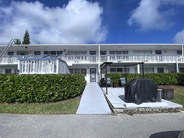 a living room with furniture a wooden floor and next to a window