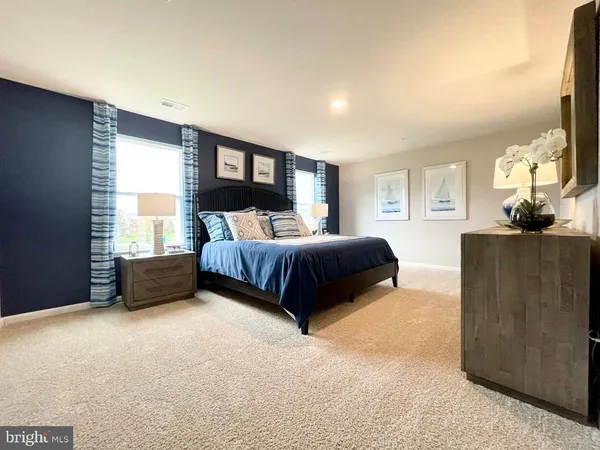 a bedroom with a bed dresser and a window