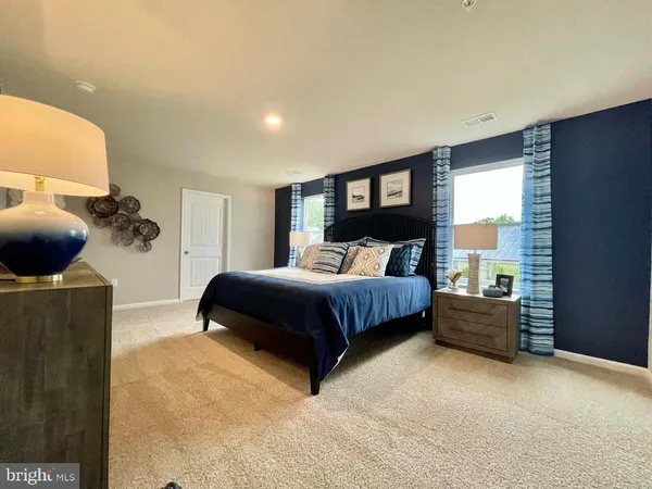 a bedroom with a bed and dresser