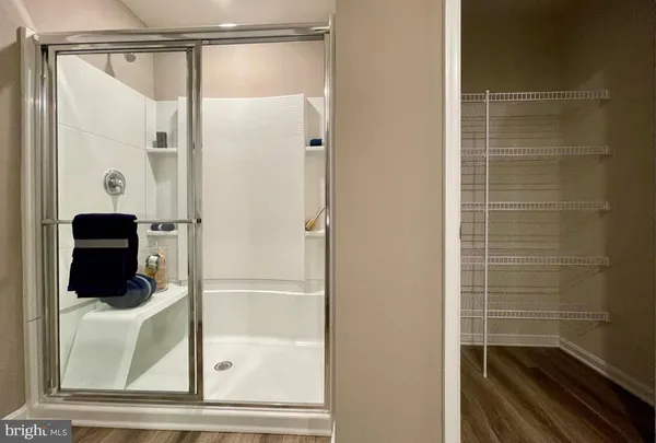 a bathroom with a glass shower door