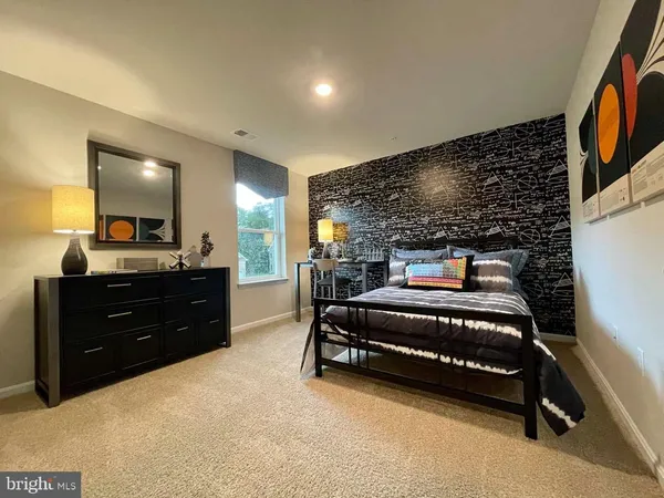 a bedroom with a bed and a mirror