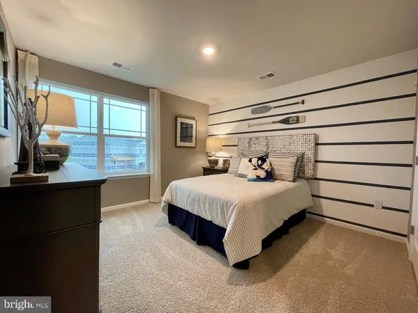 a bed room with a bed window and dresser