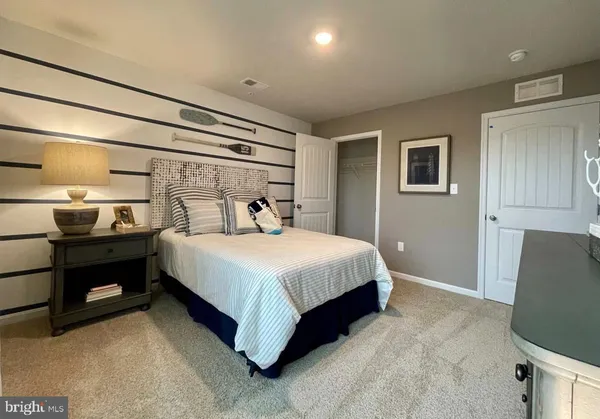 a bedroom with a bed and a television