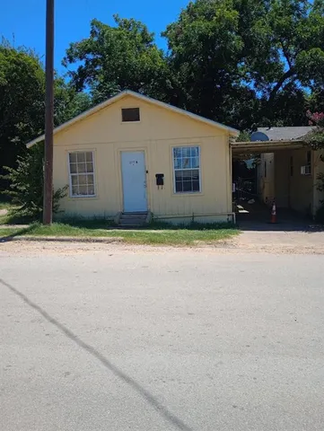 a house with trees in the background