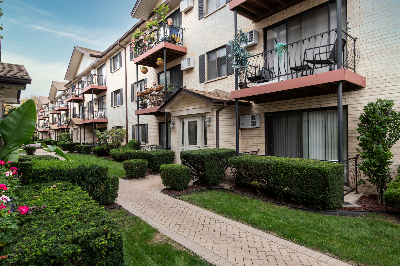 5159 North East River Road, Unit 312 Chicago, IL 60656 - Photo 1 of 42 a front view of a house with garden