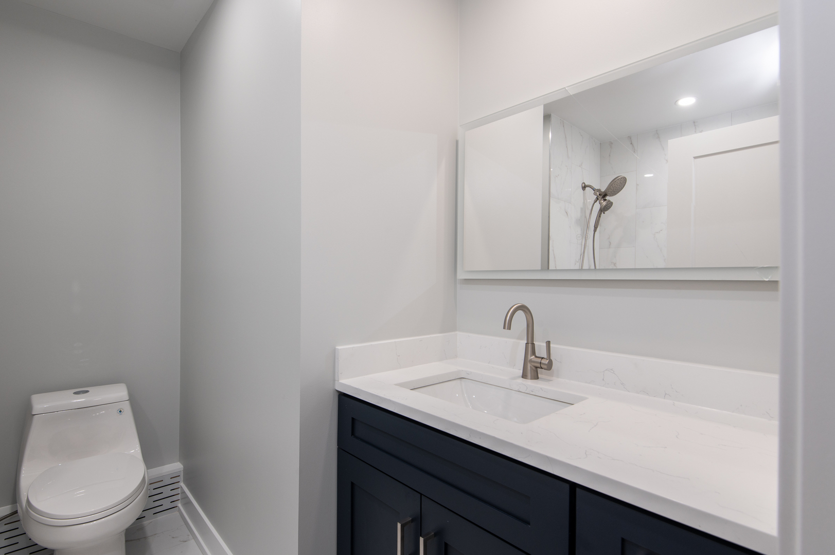 5159 North East River Road, Unit 312 Chicago, IL 60656 - Photo 26 of 42 a bathroom with a toilet sink and mirror