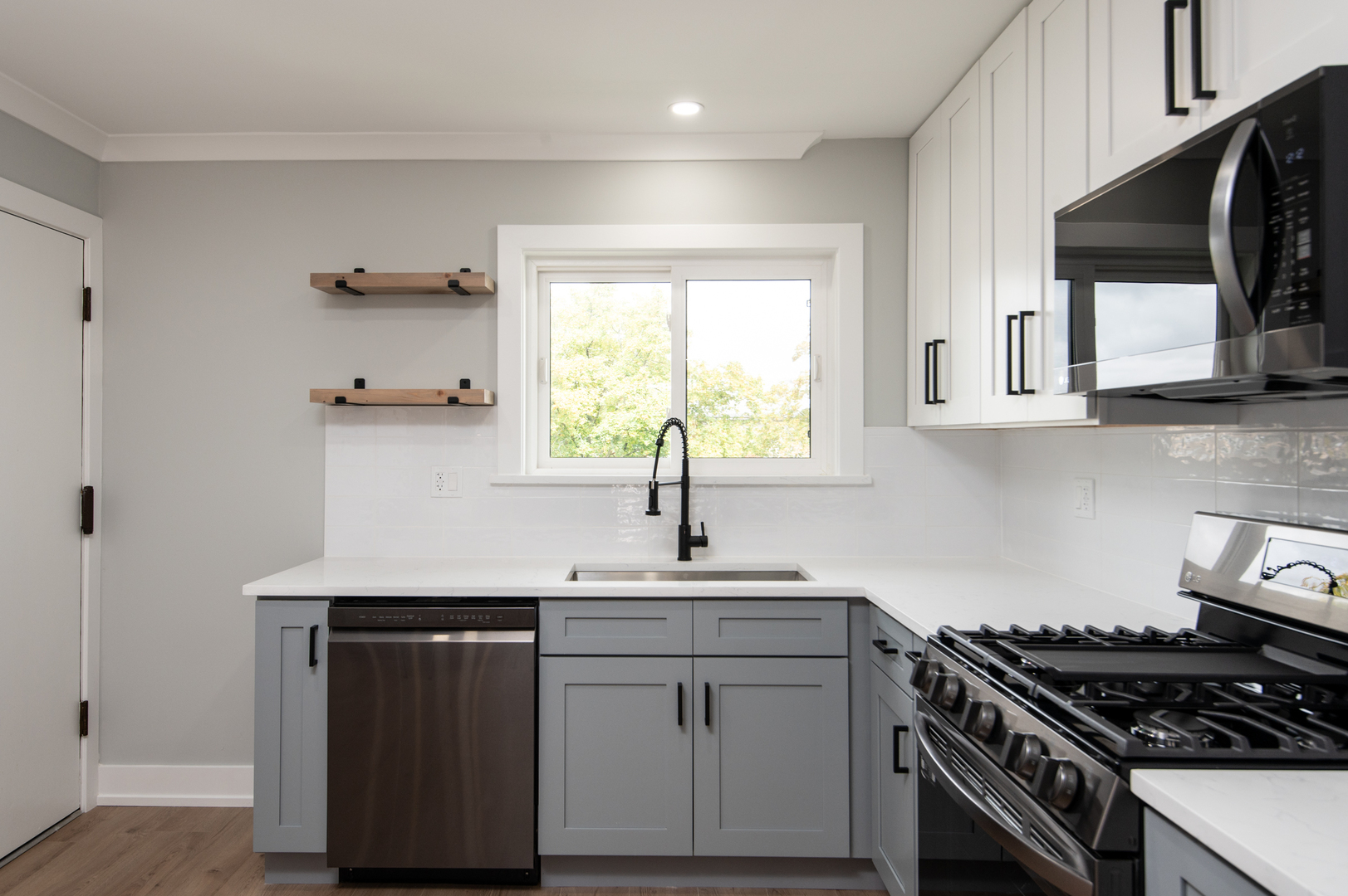 5159 North East River Road, Unit 312 Chicago, IL 60656 - Photo 4 of 42 a kitchen with stainless steel appliances a sink stove and cabinets