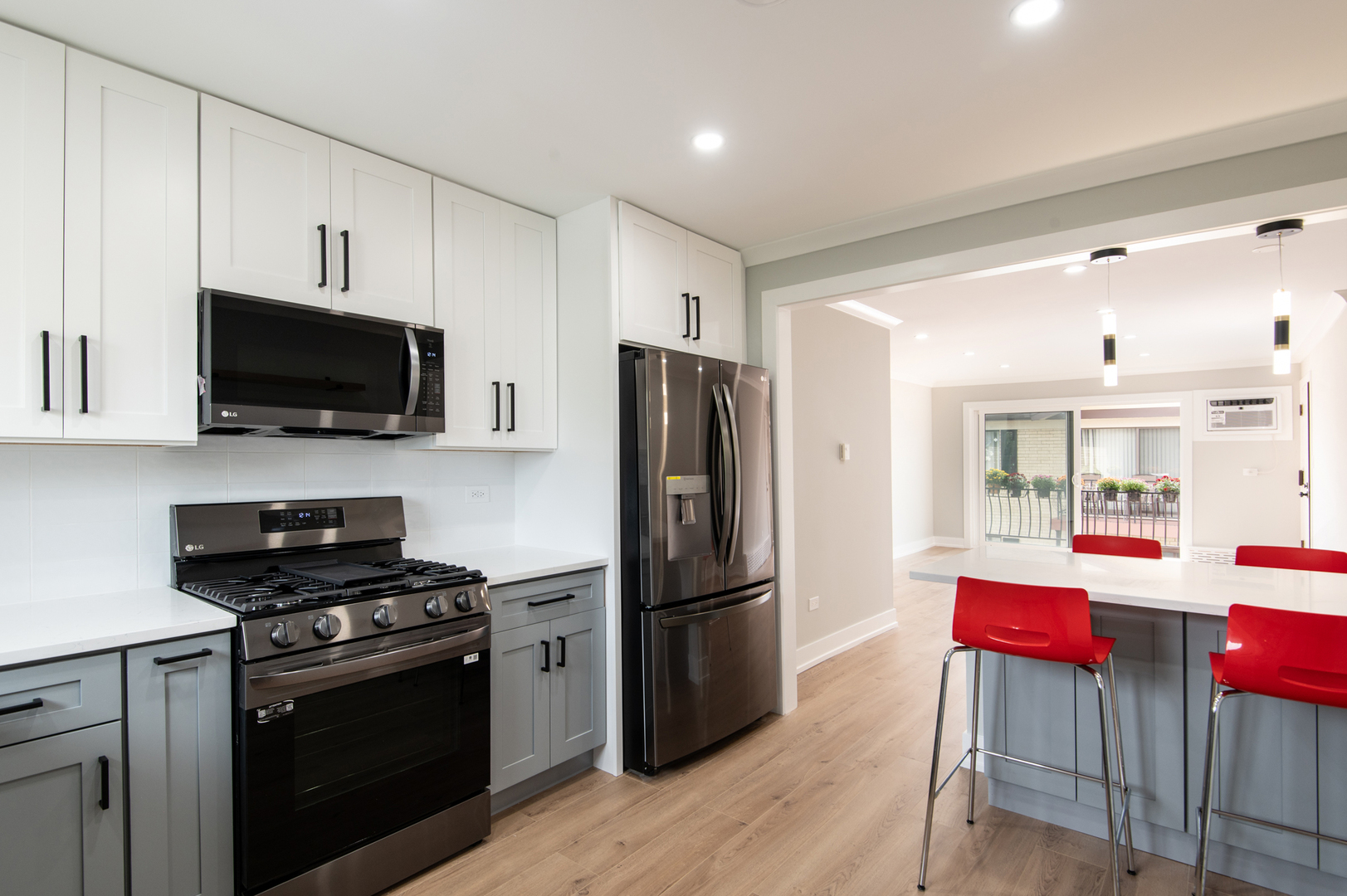 5159 North East River Road, Unit 312 Chicago, IL 60656 - Photo 6 of 42 a kitchen with stainless steel appliances granite countertop a refrigerator stove and microwave