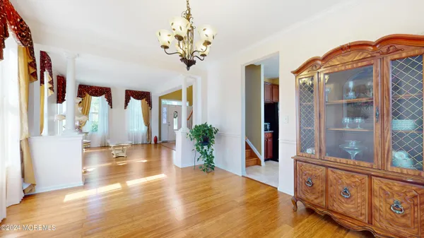 a view of an entryway with wooden floor and a chandelier