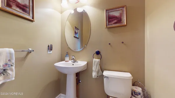 a bathroom with a toilet sink and mirror