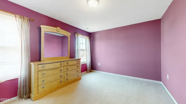 an empty room with mirror on the wall