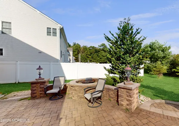 a backyard of a house with table and chairs