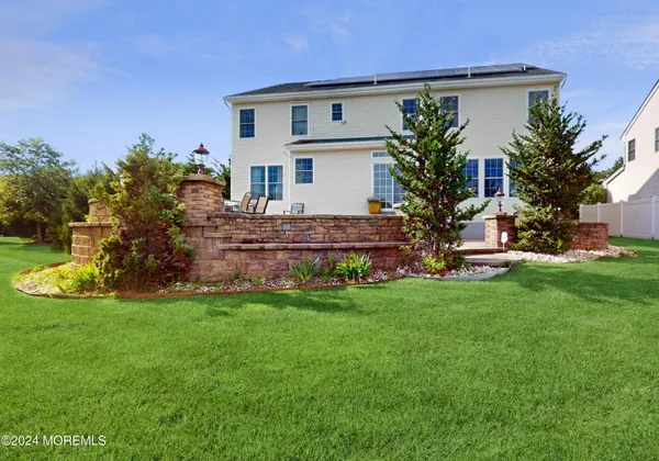 a front view of house with yard and green space
