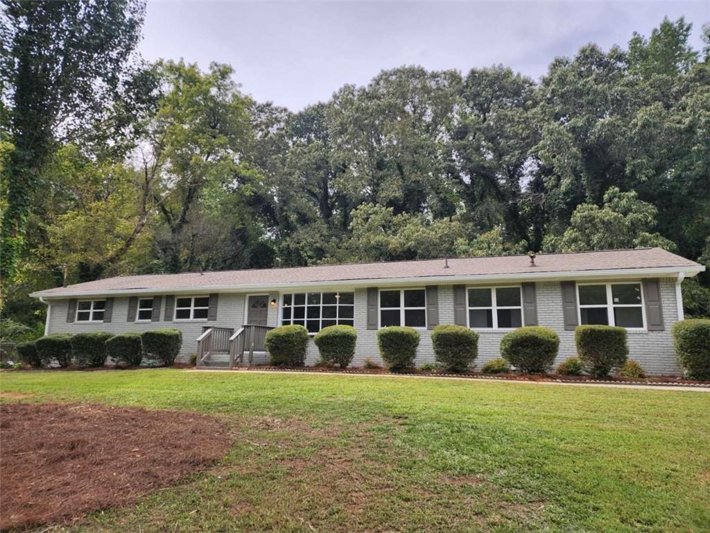 3231 Bomar Road Douglasville, GA 30135 - Photo 1 of 1 front view of a house with a yard