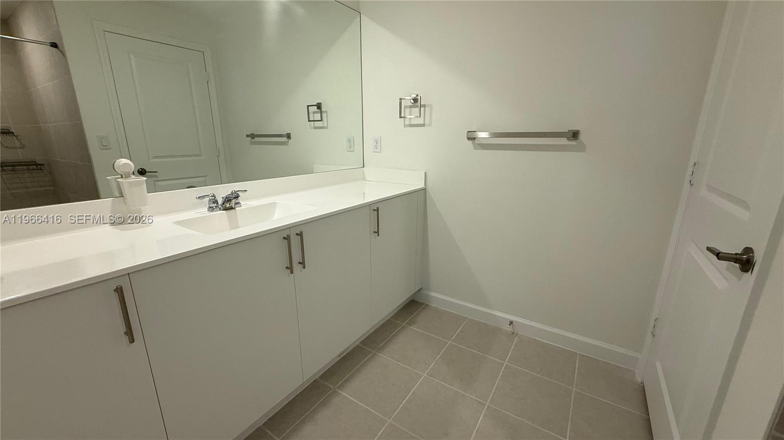 12420 Southwest 248th Street, Unit 10 Homestead, FL 33032 - Photo 13 of 16 a bathroom with a sink and mirror