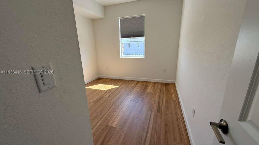 12420 Southwest 248th Street, Unit 10 Homestead, FL 33032 - Photo 16 of 16 a view of wooden floor