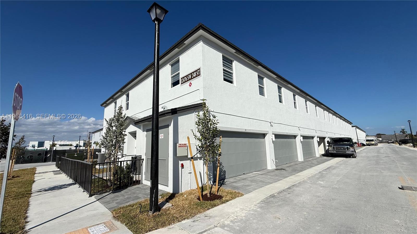 12420 Southwest 248th Street, Unit 10 Homestead, FL 33032 - Photo 2 of 16 a front view of a house with a yard