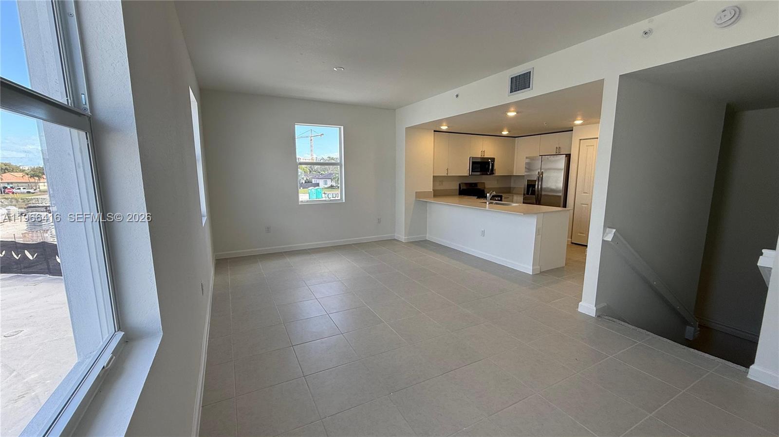 12420 Southwest 248th Street, Unit 10 Homestead, FL 33032 - Photo 3 of 16 a living room with stainless steel appliances a large window
