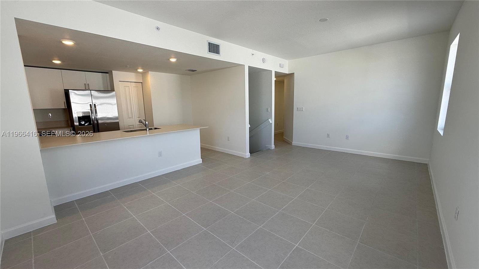 12420 Southwest 248th Street, Unit 10 Homestead, FL 33032 - Photo 4 of 16 a view of a kitchen with a sink and a large window