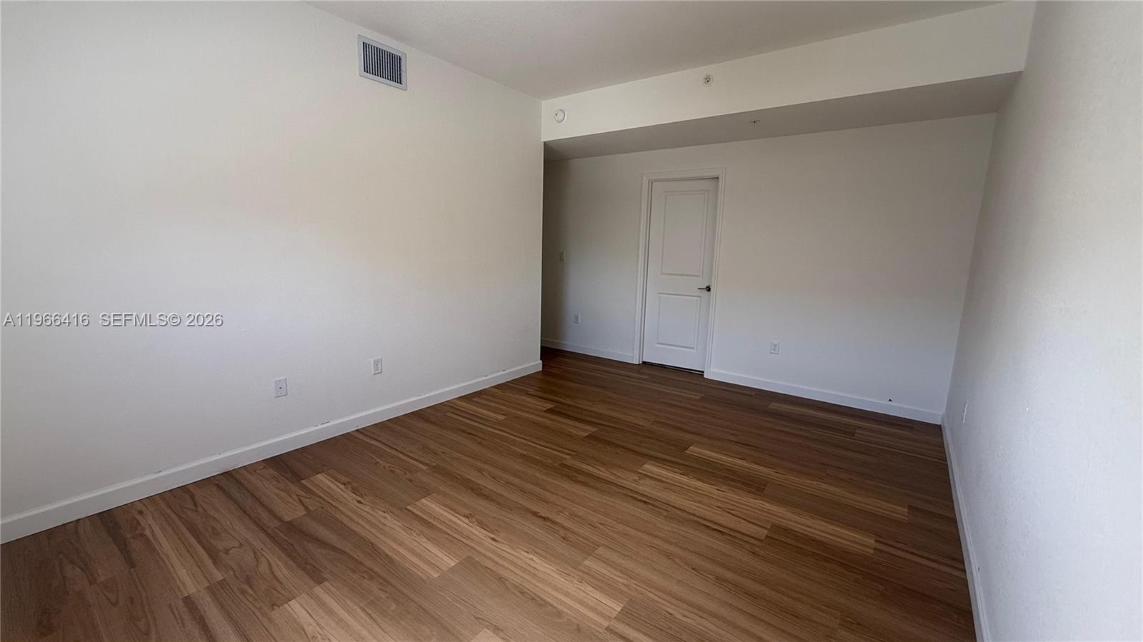 12420 Southwest 248th Street, Unit 10 Homestead, FL 33032 - Photo 9 of 16 a view of empty room with wooden floor