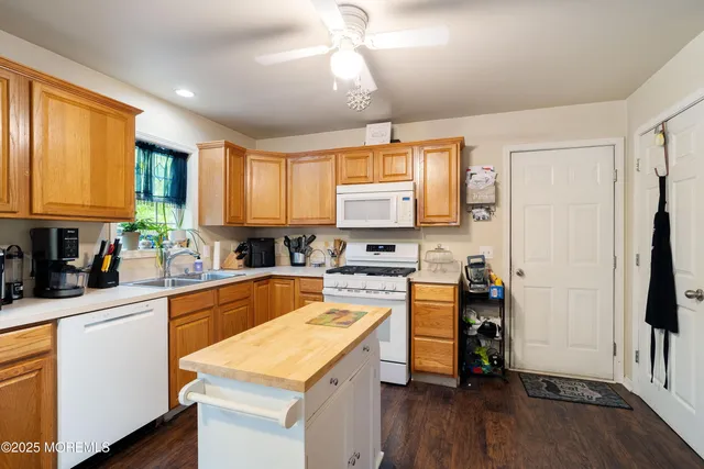a kitchen with a stove a sink and a refrigerator