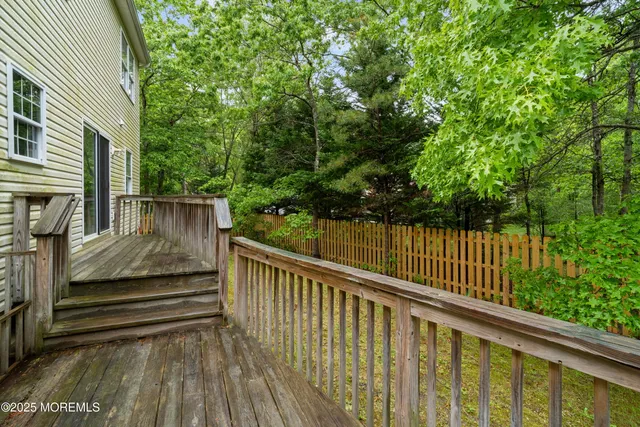 a view of balcony with wooden floor and fence