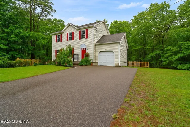 a front view of house with yard and green space