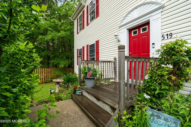 a view of a house with a small yard and flower plants