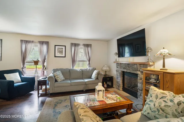 a living room with furniture flat screen tv and a fireplace