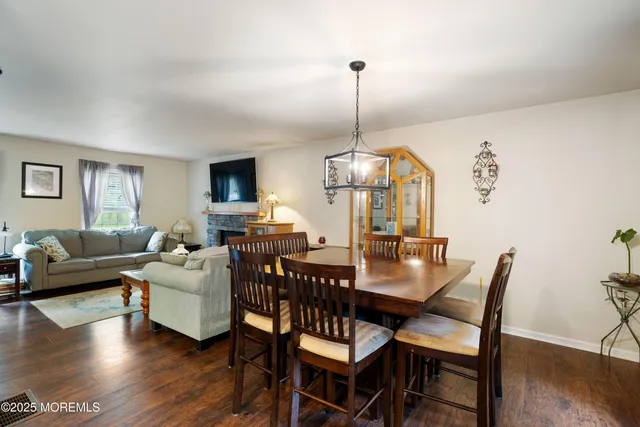 a view of a dining room with furniture wooden floor and chandelier